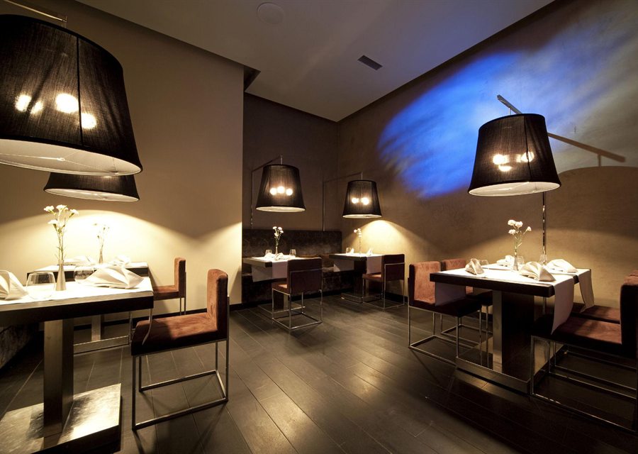 Restaurant interior with warm lighting and tables set for service